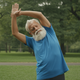 AI Generated Cover: Show an elderly gentlement stretching in the park,